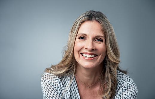 Women smiling after recieving dental implants from Lauren Becker DDS, PC 