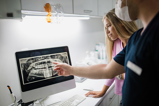 Dr. and patient discussing biomimetic option for tooth preservation at Lauren Becker DDS, PC
